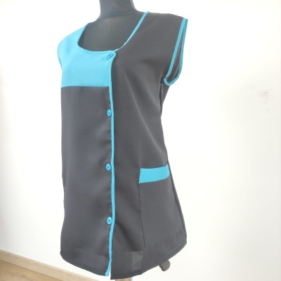 Blusa preta e azul turquesa sem mangas com botões azuis exibida num manequim