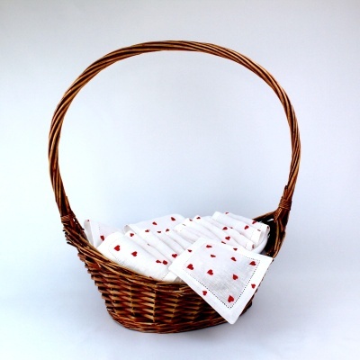 Cesto de verga com toalhas brancas e corações vermelhos