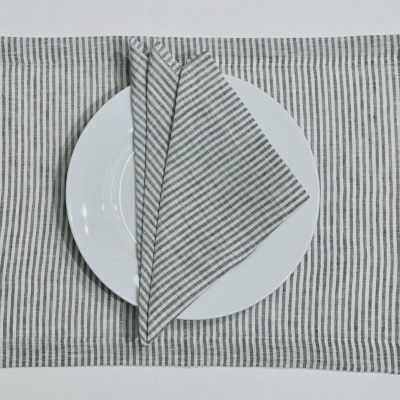 Individual e guardanapo cinzentos com riscas finas e prato branco