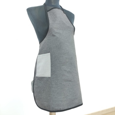 Avental cinzento com bolso branco num manequim cinza escuro