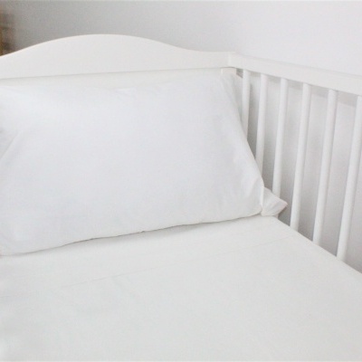 Berço branco com colchão e almofada brancos