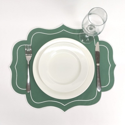 Conjunto de jantar com pratos brancos, talheres, copo e base verde decorativa