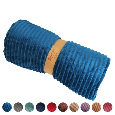 Manta azul turquesa felpuda enrolada com faixa de papel