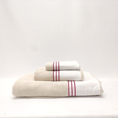 Conjunto de toalhas bege com detalhes em branco e vermelho