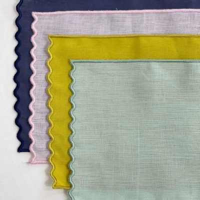 Quatro lenços coloridos com bordas onduladas em tecido fino