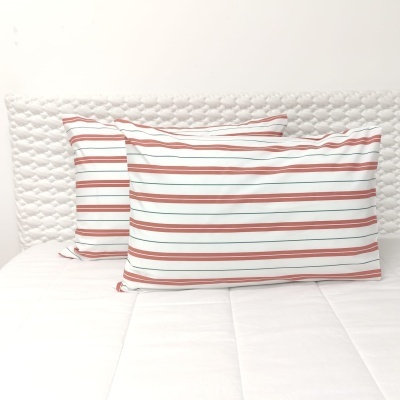 Almofadas com riscas horizontais coloridas em cama branca