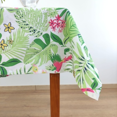 Toalha de mesa com padrão tropical colorido sobre mesa de madeira