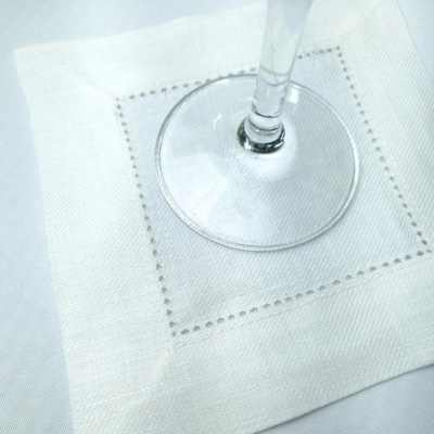 Guardanapo branco com bordado e base de taça de vidro
