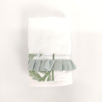 Toalha branca com padrão de folhas verdes e folhos verdes