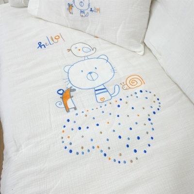 Colcha branca com desenho infantil de gato, pássaro, cão, caracol e texto 'hello!' em cores azul, laranja e cinza