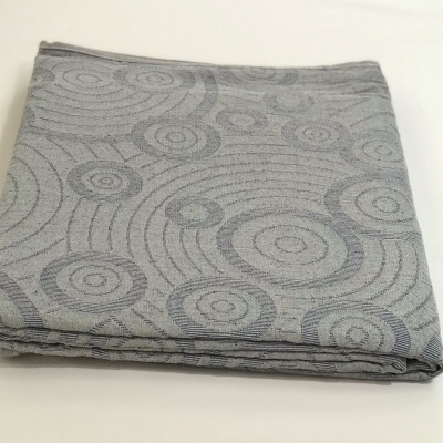 Toalha de mesa cinza com padrão circular dobrada