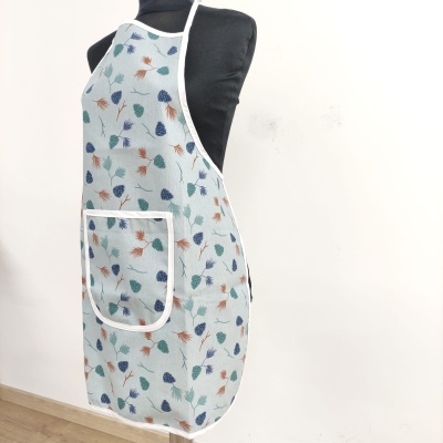 Avental de tecido com padrão de folhas em azul, verde e castanho