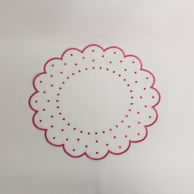 Toalha redonda branca com rebordo ondulado rosa e padrão circular perfurado