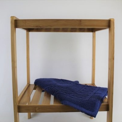 Estante de madeira clara com manta azul tricotada na prateleira inferior