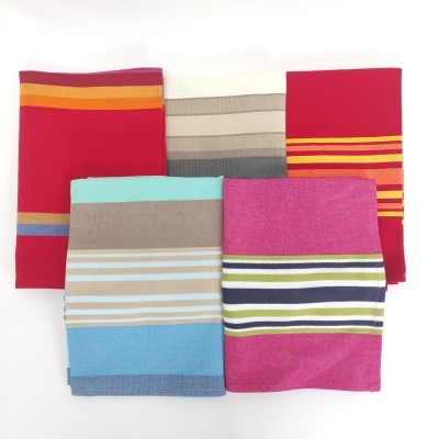 Cinco tecidos listrados coloridos dobrados sobre fundo branco