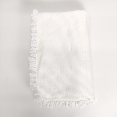 Manta branca texturizada com bordos de folhos