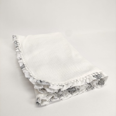 Toalha branca texturizada com borda floral cinzenta e pompons