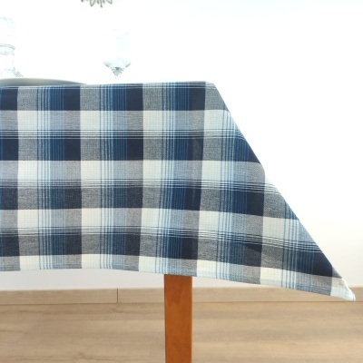 Toalha de mesa azul e branca xadrez sobre mesa de madeira