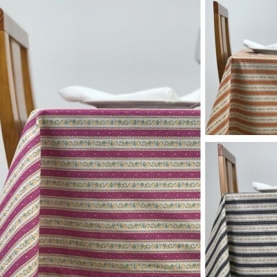 Mesa com toalhas de mesa listradas em várias cores e cadeira de madeira