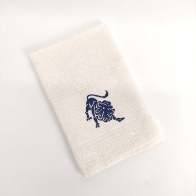 Toalha branca com bordado azul de leão