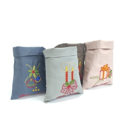 Sacolas de tecido natalícias com bordados coloridos e fundo branco