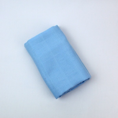 Toalha azul clara dobrada sobre fundo branco