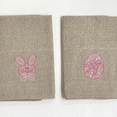 Dois panos de cozinha bege com bordados rosa de coelho e ovo de Páscoa