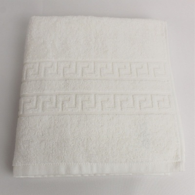 Toalha branca com padrões geométricos em relevo