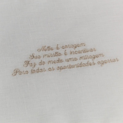 Tecido branco com bordado bege com texto