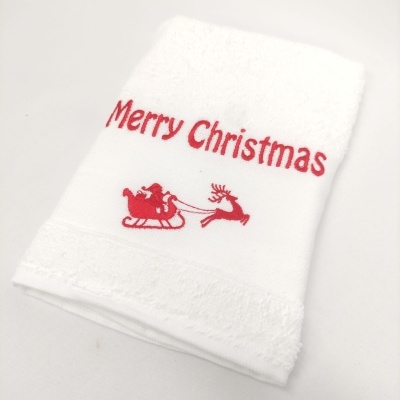 Toalha branca com bordado vermelho Merry Christmas e imagem do Pai Natal no trenó com rena