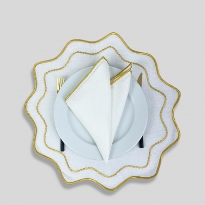 Conjunto de prato branco com jogo americano e guardanapo branco com bordas douradas