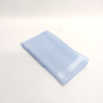 Toalha azul claro dobrada sobre fundo branco