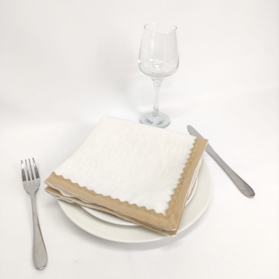 Talheres, prato branco, taça de vidro e guardanapos de papel branco com bordas castanhas