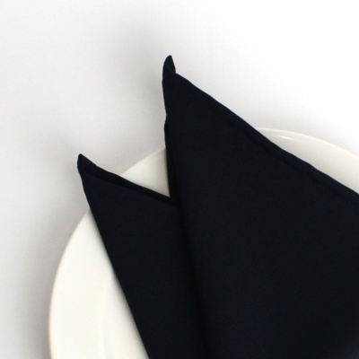 Guardanapo preto dobrado sobre prato branco