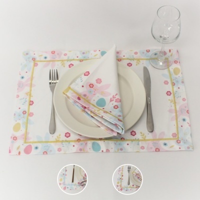 Conjunto de loiça branca com padrão floral colorido e talheres metálicos