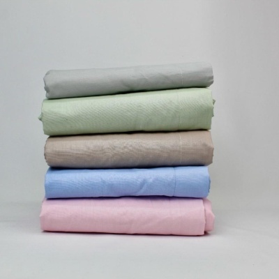 Cinco panos de algodão dobrados empilhados em várias cores pastel