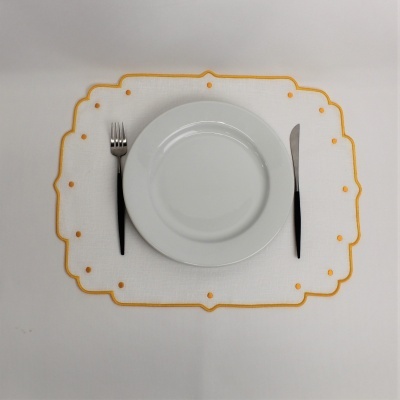 Lugar de mesa branco com bordo amarelo, prato branco, garfo e faca