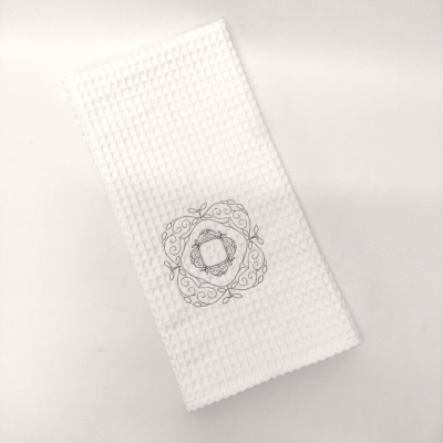 Toalha branca com bordado cinza e padrão quadrado