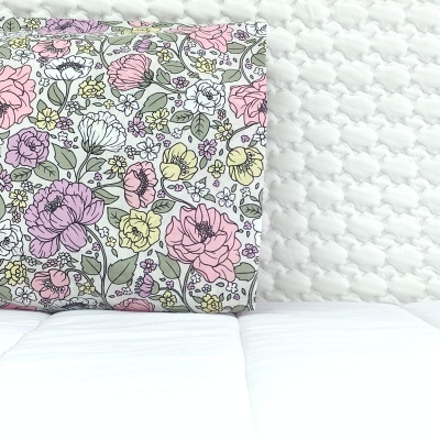 Colchão branco texturizado com almofada floral colorida