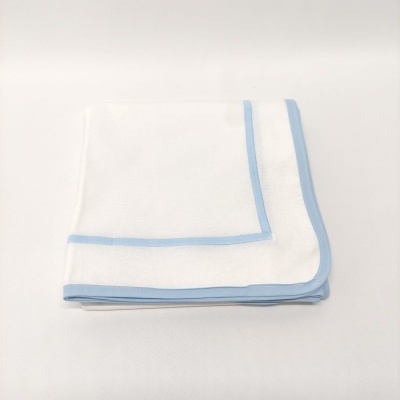Toalha branca com borda azul clara dobrada