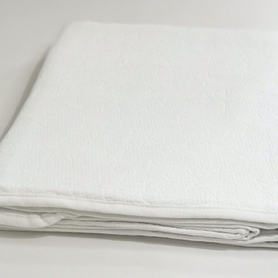 lençol branco dobrado sobre superfície branca