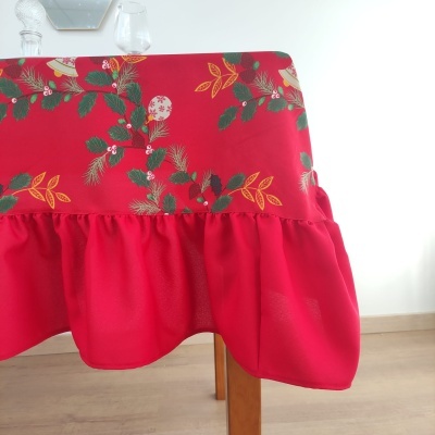 toalha de mesa vermelha com padrão de folhas e bagas numa mesa