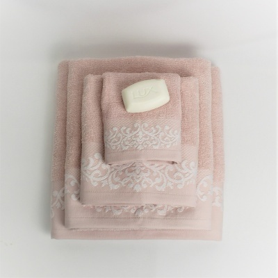 Conjunto de toalhas rosa claro com padrão branco e sabonete Lux