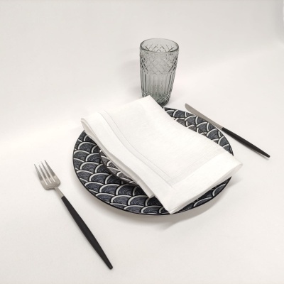 Conjunto de prato, guardanapo, talheres e copo em fundo branco