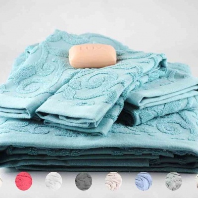 Conjunto de toalhas azuis com padrão e sabonete em fundo branco