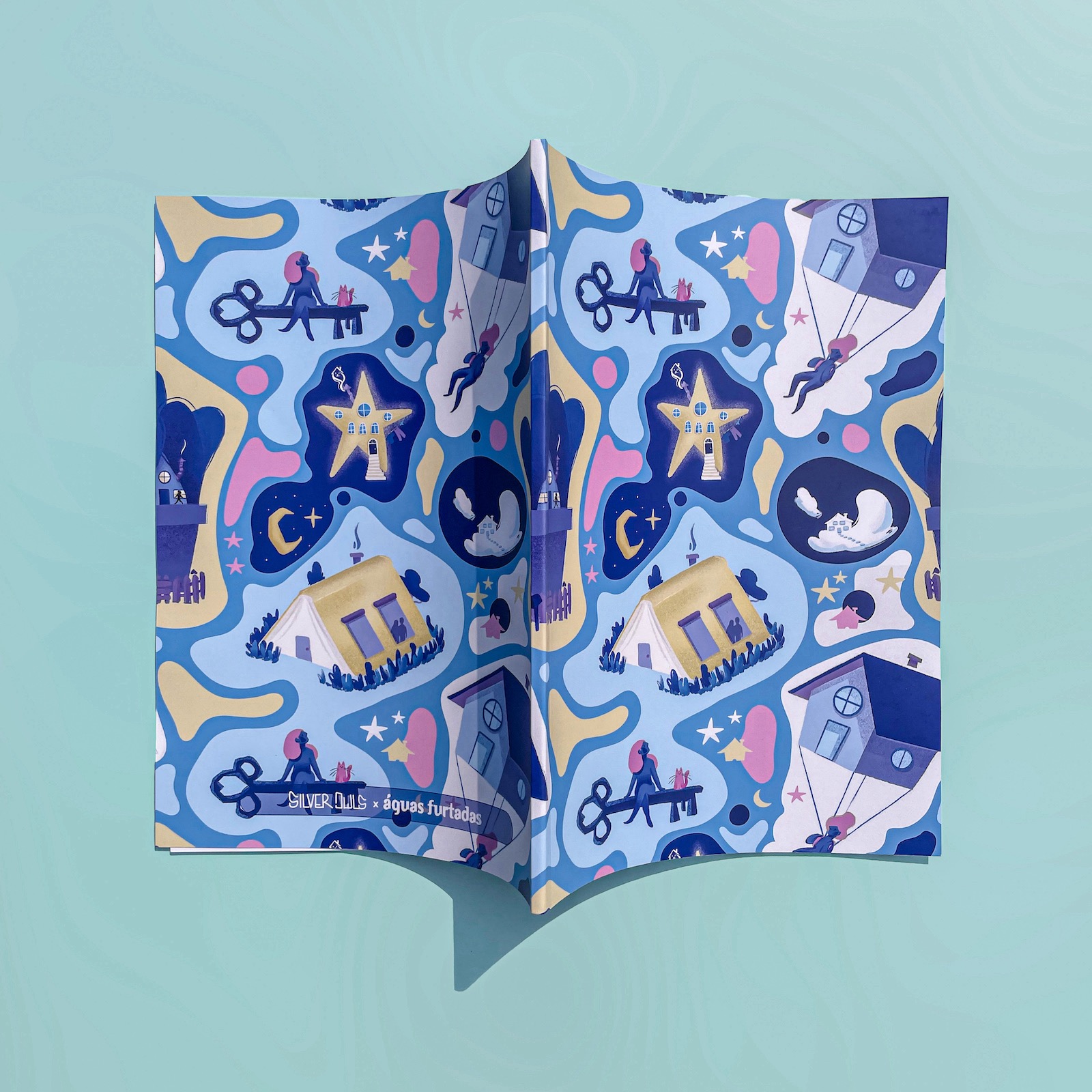 CADERNO A4 "TER UMA CASINHA PARA VIVER" ANDREIA SANTOS Capa de livro colorida com padrões temáticos em azul, amarelo e rosa