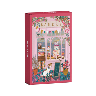 Caixa rosa decorada com uma ilustração de pastelaria, bolos, cão e plantas.