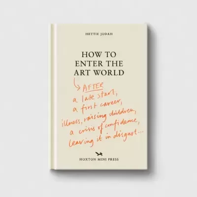 Livro capa dura bege com texto preto e vermelho