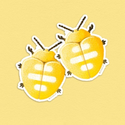 Dois autocolantes em forma de besouro amarelo com manchas brancas