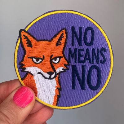 Patch bordado redondo com raposa laranja e texto NO MEANS NO sobre fundo roxo